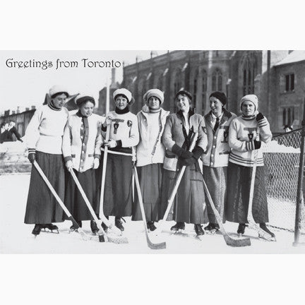 Seven women hockey-players from the University of Toronto in long skirts and team sweaters with hockey sticks circa 1912